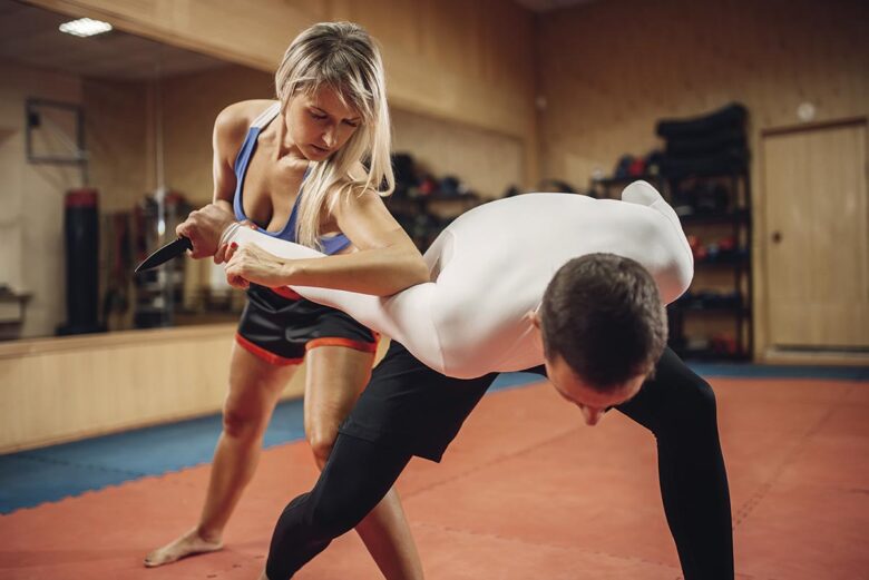 Woman makes elbow kick, self defense workout