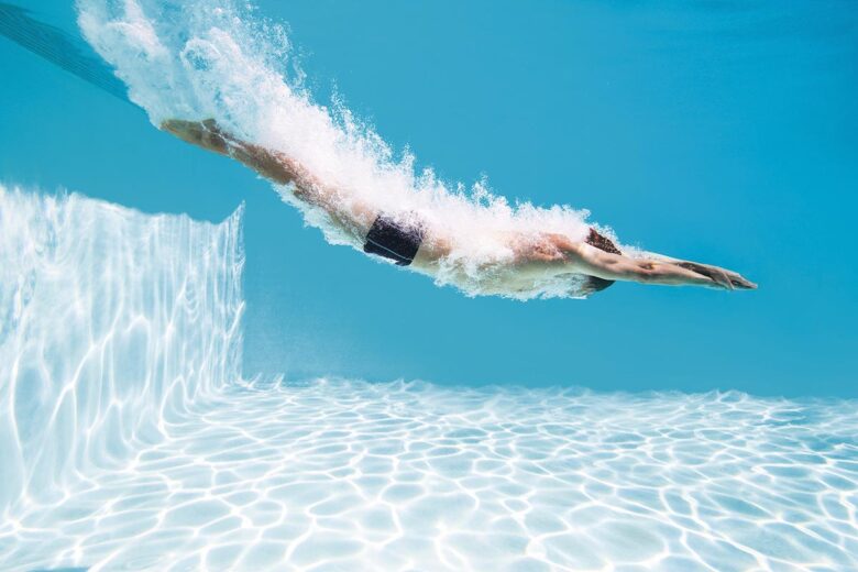 Man diving into swimming pool