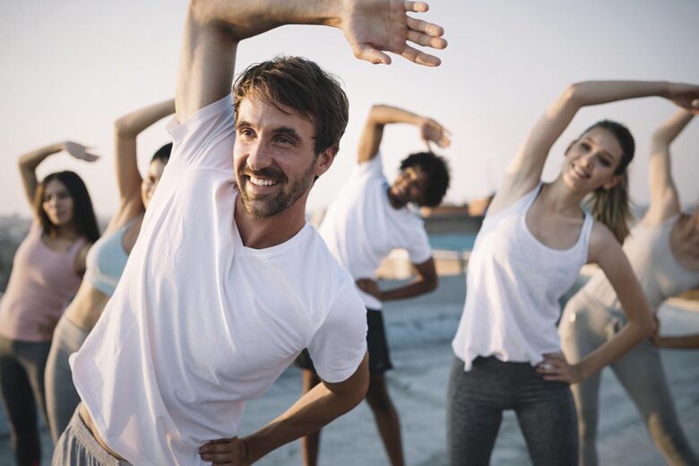 Fitness, sport, friendship and healthy lifestyle concept . Group of happy people exercising