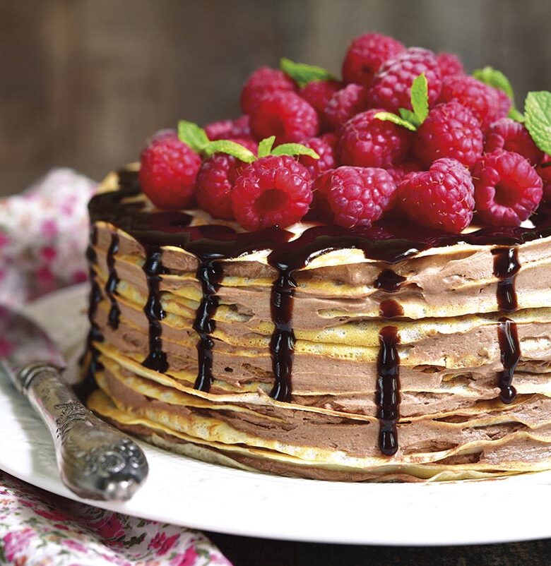 Pancake chocolate cake with fresh raspberry.