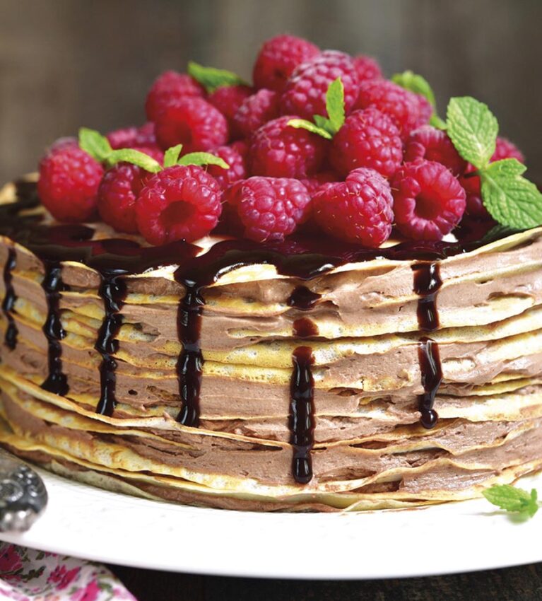 Pancake chocolate cake with fresh raspberry.