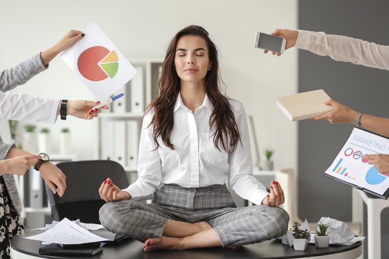 Businesswoman with a lot of work to do meditating in office