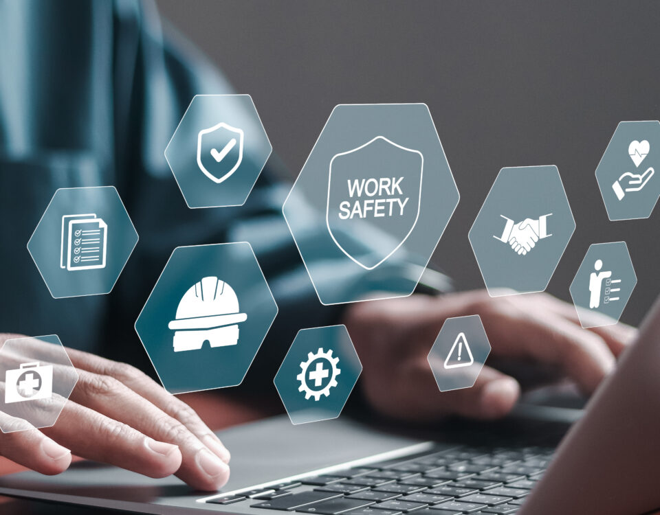 Work safety concept. Businessman use laptop with safety icons on virtual screen for working standard process and zero accidents. regulations and standard in industry.